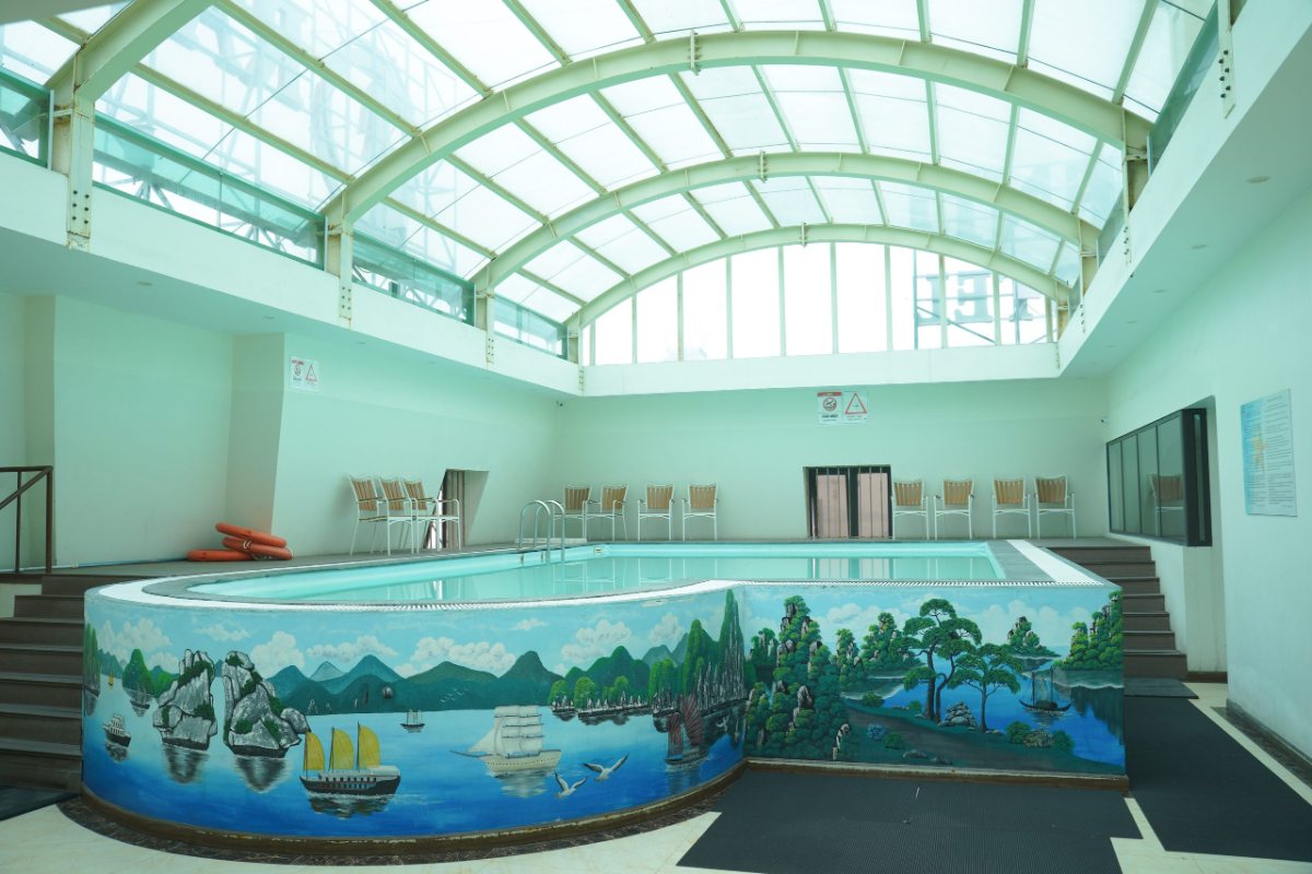 Indoor pool with Ha Long Bay painting at Dragon Legend Hotel