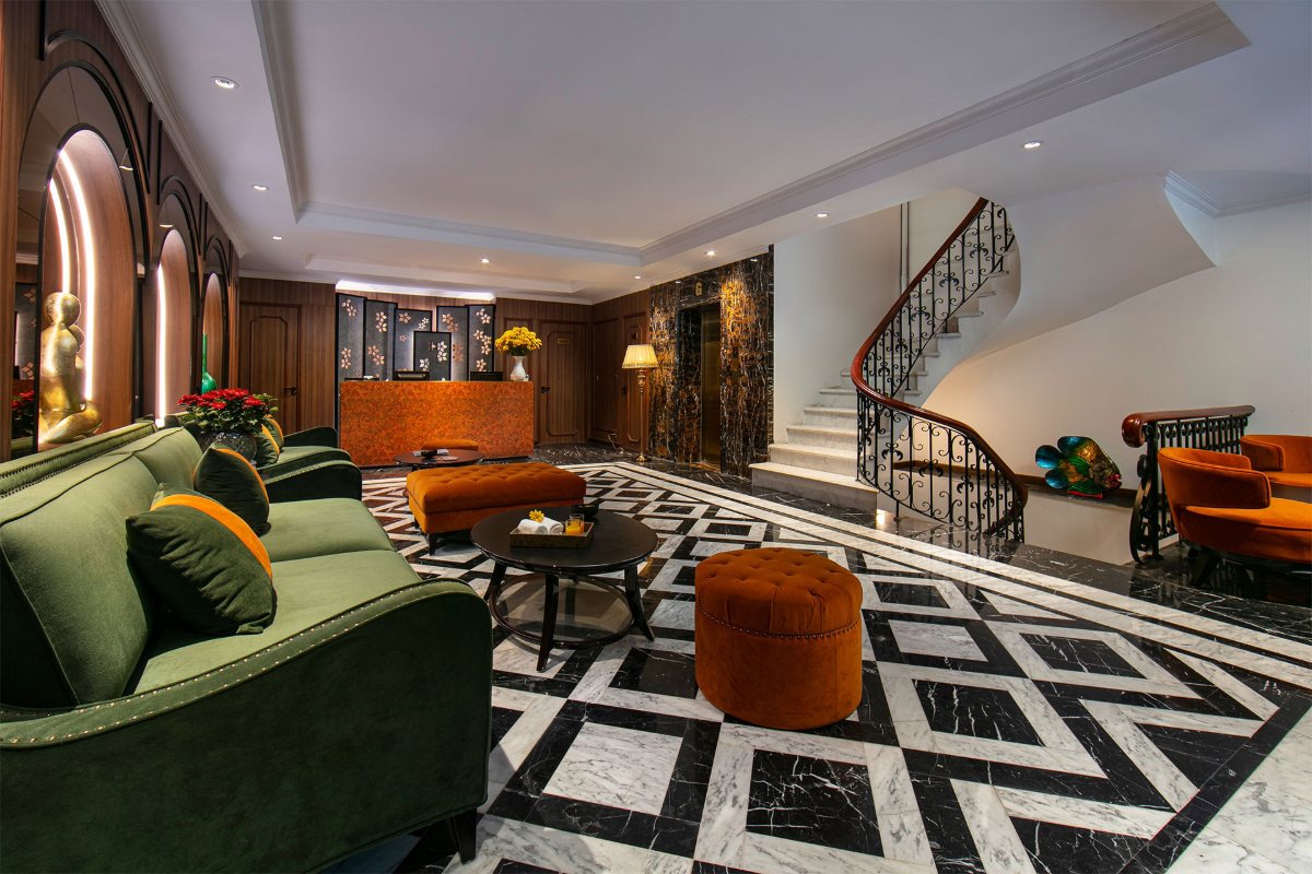 Lounge with green sofas at Hanoi L'Heritage Hotel