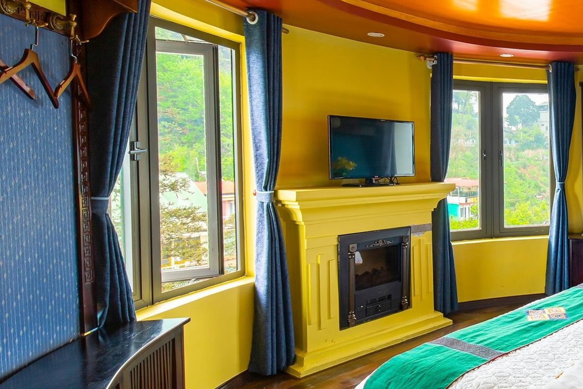 Junior Suite corner room with fireplace and window view at Sapa House Hotel