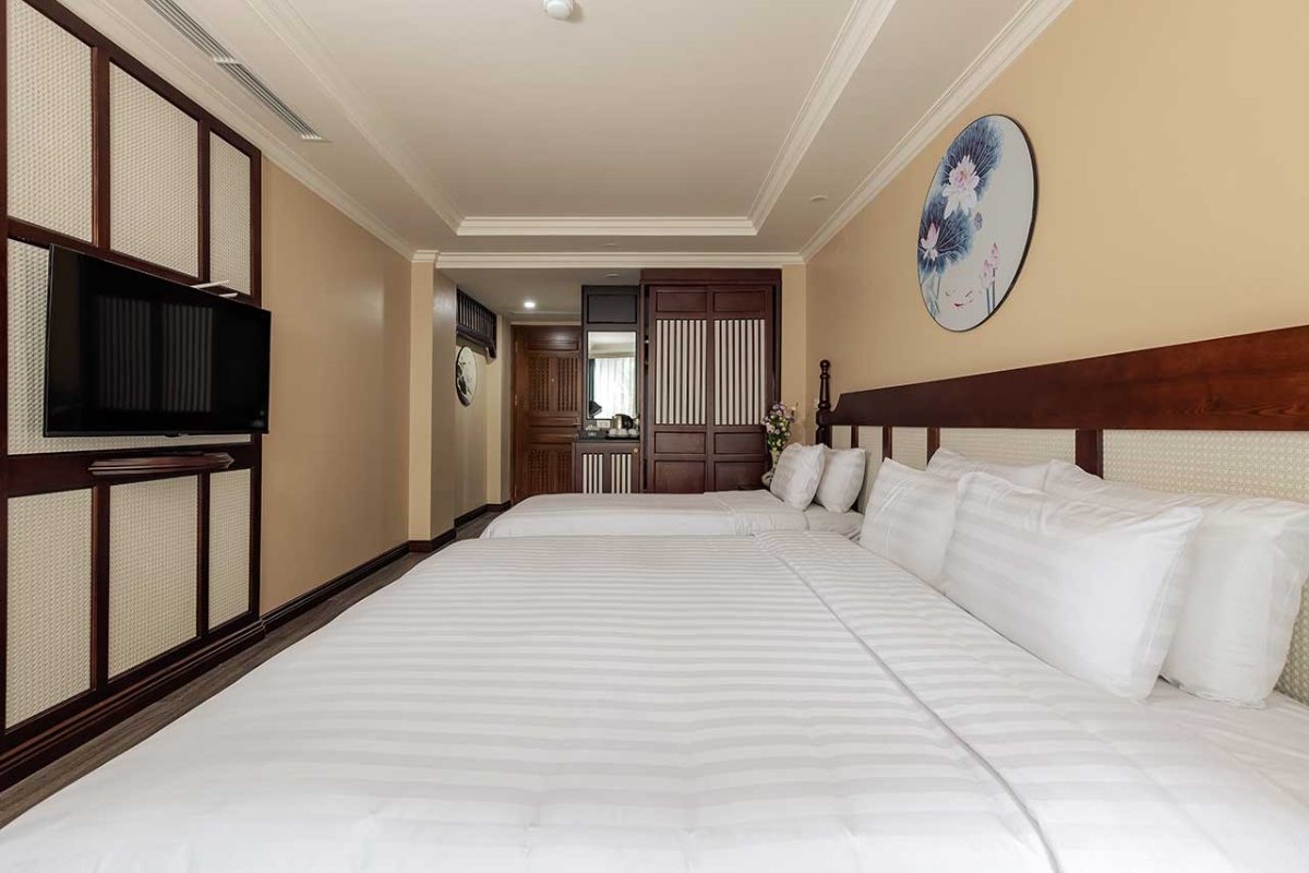 King and single beds in the Family Triple Balcony at Lotusama Hanoi Hotel