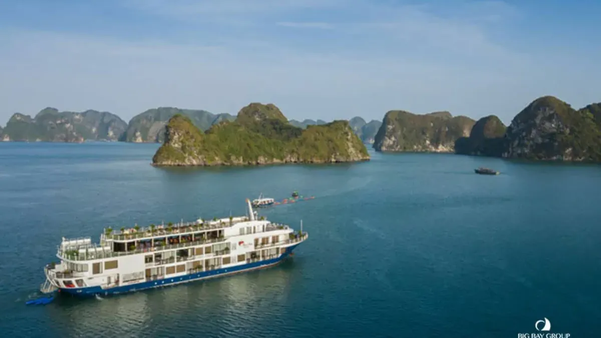 Mon Cheri Cruise sailing past limestone karsts in Halong Bay