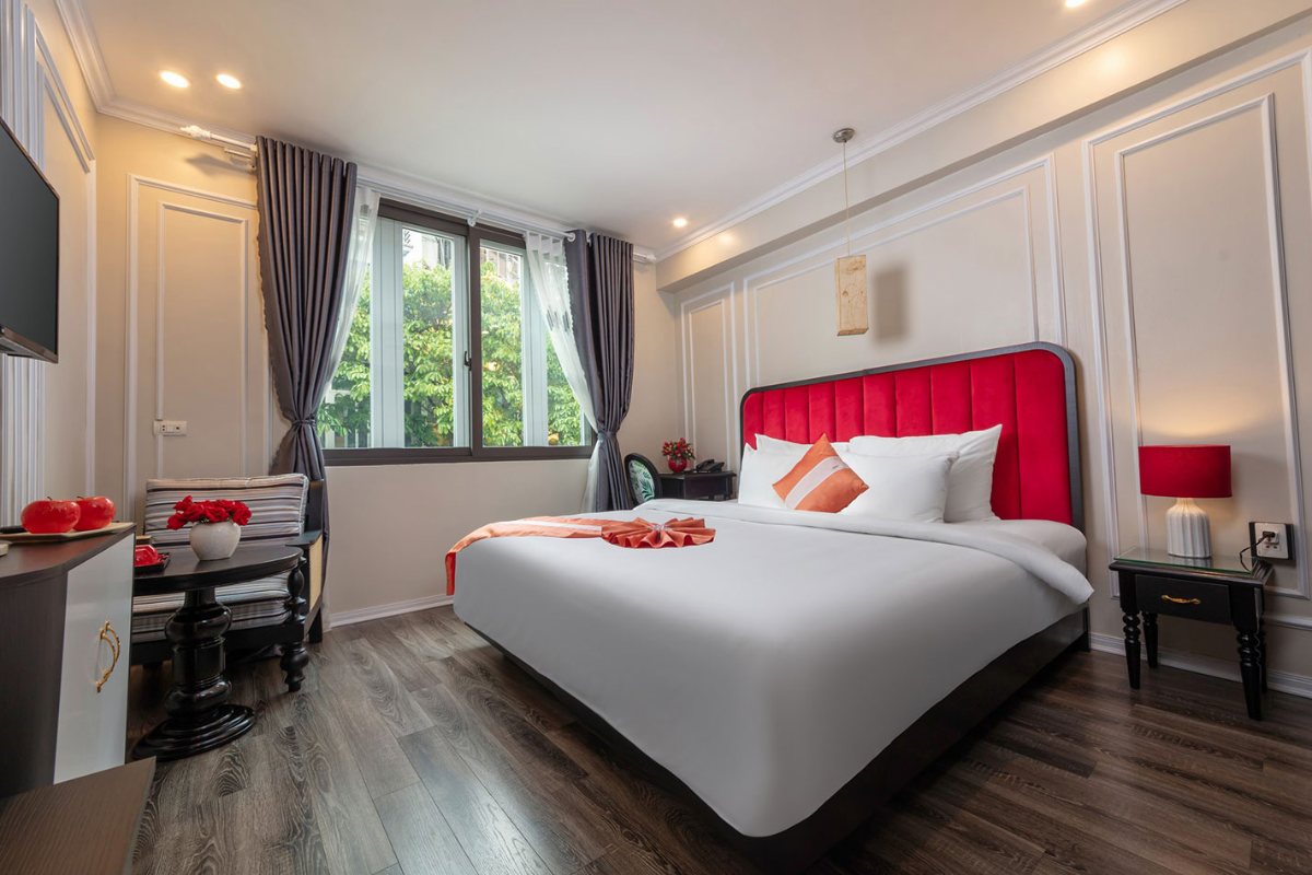 Deluxe Suite with city-view windows at Omina Hanoi Hotel