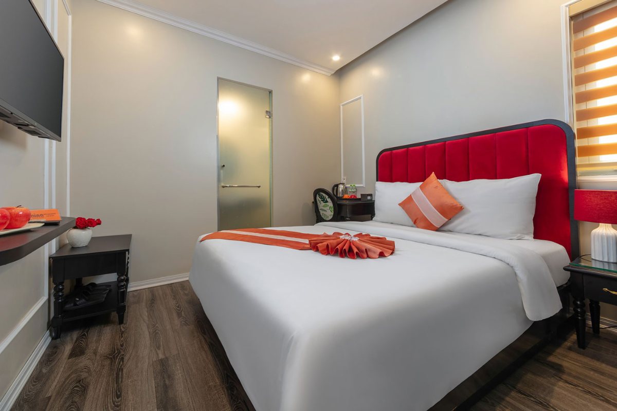 Superior Double Room with red headboard at Omina Hanoi Hotel