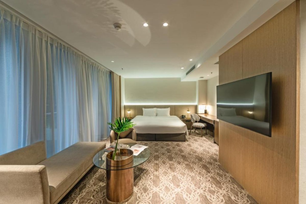 Living area of the Deluxe King Studio at REY Hotel Hanoi